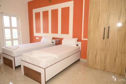 a bedroom with two beds and a cabinet at shangrila stay in Bodh Gaya