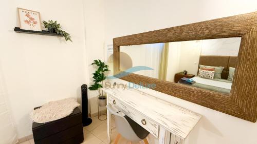 a bathroom with a large mirror on the wall at Villa Clara Premium by Sunny Deluxe in Albufeira