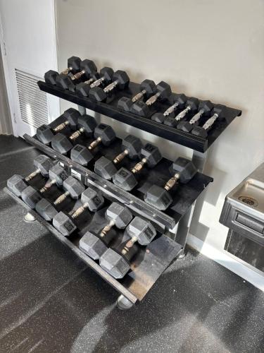 a rack of dumbbells in a gym at Ocean View Studio Wkitchen On Sunny Isles Beach! in Sunny Isles Beach