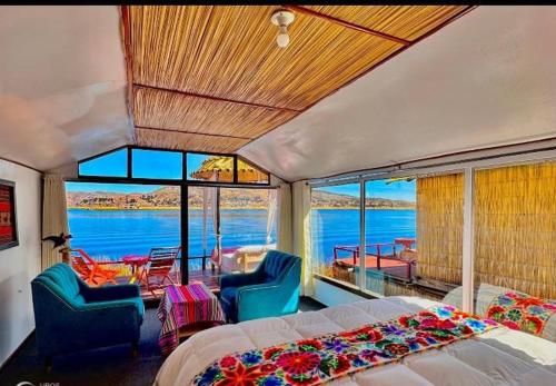 a bedroom with a bed and a view of the water at Titicaca posada del sol lodge in Puno