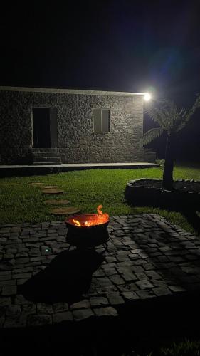 a fire pit in the middle of a yard at night at Almorão in São Francisco de Paula