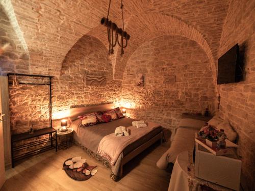 a bedroom with a bed in a stone wall at I CAVALIERI in Terlizzi
