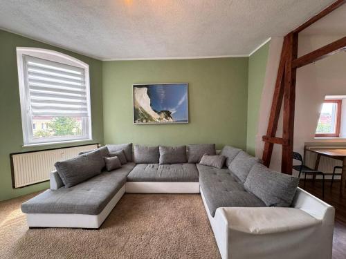 a living room with a couch and a table at Beautiful apartment for 5-7 guests in Zeitz