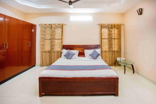 a bedroom with a large bed and a glass table at HEAVEN PLEASANT STAy in Chennai