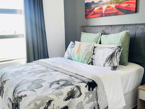 a bedroom with a bed with a comforter and pillows at 2Bedroom Luxury Family Living Space in Midrand in Midrand