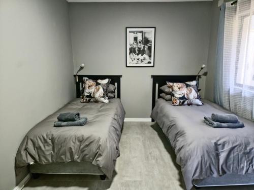 two beds with stuffed animals on them in a bedroom at Lagoon View Serenity! in Knysna