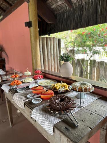 a table with many plates of food on it at Vila ORIBA in Santo André