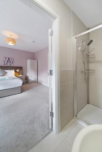 a bedroom with a bed and a shower and a bathroom at Westpoint in Donegal
