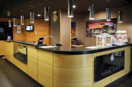 a kitchen with a counter with a sink and a counter at Hotel Conde Duque Bilbao in Bilbao