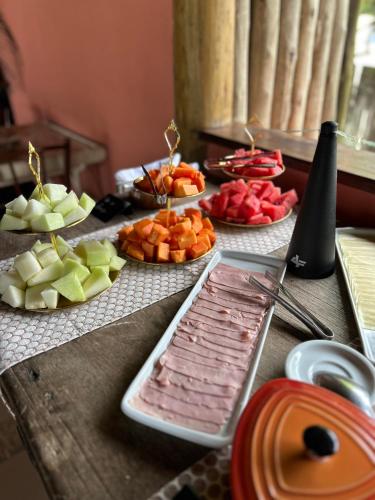 サントアンドレにあるPousada ORIBÁのさまざまな種類の果物が皿に盛られたテーブル