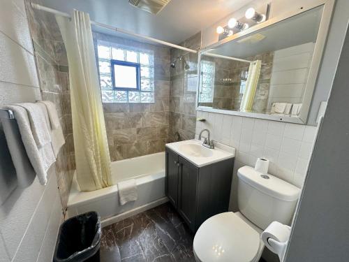 a bathroom with a toilet and a sink and a mirror at Des Plaines Motel By OYO O'Hare Airport Chicago in Des Plaines