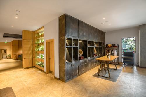 a kitchen with a table and a dining room at The Social House Nairobi, a Preferred Lifestyle Hotel in Nairobi