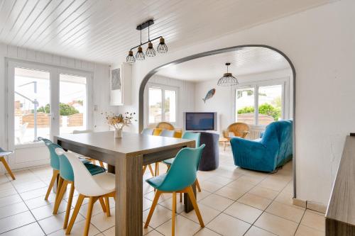 une salle à manger et un salon avec une table et des chaises dans l'établissement Maison à Barbâtre pour 10 - 450m de la plage, à Barbâtre