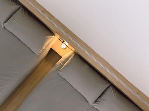 a light on top of a bed in a room at 泊寓 boyü in Lugang