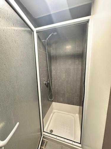 a shower with a glass door in a bathroom at Azor International Hostel in Ponta Delgada
