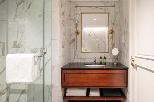 a bathroom with a sink and a mirror at Cheval Maison - Expo City Dubai in Dubai