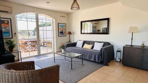 a living room with a couch and a table at Seabird Appartement Lumineux Port Grimaud in Grimaud