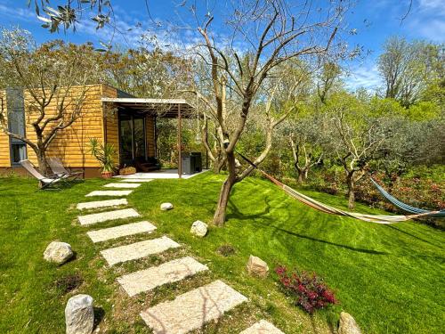 a garden with a tree and a stone pathway at Seregnér Agricamping & Homes - Adults Only 18 in Monzambano