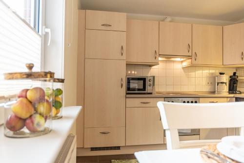 a kitchen with a bowl of fruit on a counter at Südstern EG, Schwalbenweg in Südstrand