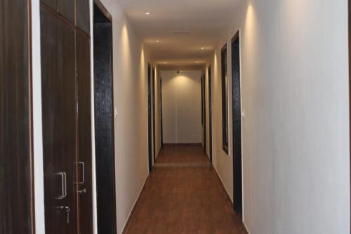 a hallway with a row of doors and a long corridor at Black Diamond Hotel & Spa in Zirakpur