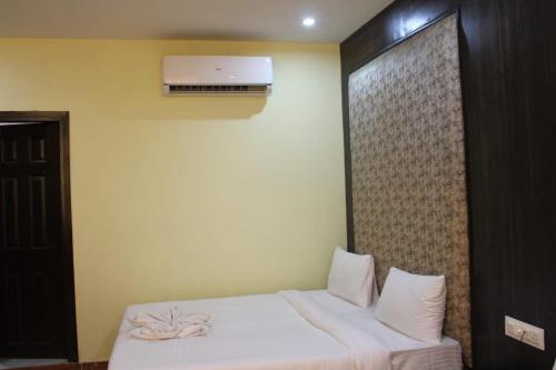 a bedroom with a bed and a air conditioner at Black Diamond Hotel & Spa in Zirakpur