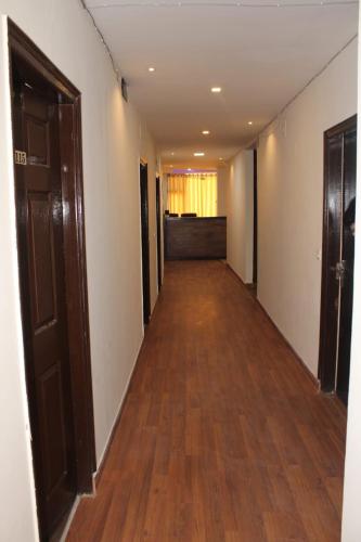 an empty hallway with wood floors and doors at Black Diamond Hotel & Spa in Zirakpur