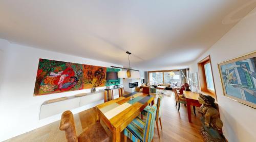 a dining room with a table and some chairs at Schweizerhaus Apartments in Maloja