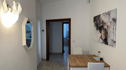 a dining room with a table and a mirror at La Casa Bianca Rooms&Lounge in Cesenatico