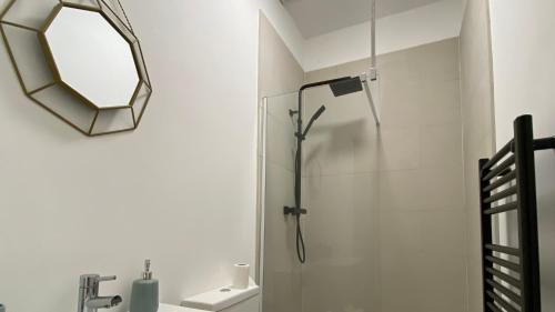 a bathroom with a shower and a mirror at De Parys Flat 1 in Bedford in Bedford