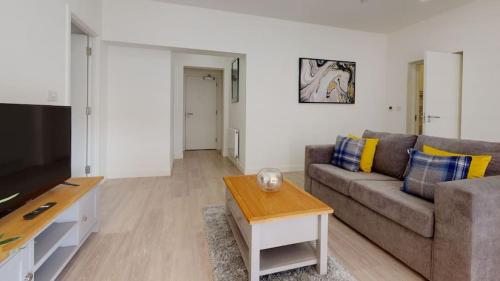 a living room with a couch and a table at Luxury Apartment - Town Centre North Stevenage in Stevenage