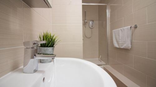 a bathroom with a sink and a toilet and a shower at StayZo Premiere Serviced Accommodation-17 in Southampton