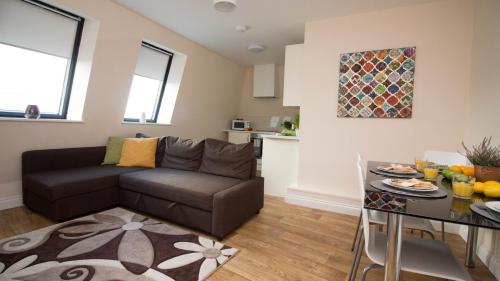 a living room with a couch and a table at StayZo Serviced Accommodation 16 Premier Lodge in Southampton