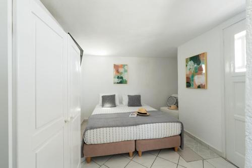 a bedroom with a bed in a white room at SeaView Central Suites in Mýkonos City