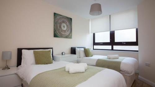 a bedroom with two beds and a window at StayZo Castle Point 6 Apartment - Premier Lodge in Southampton