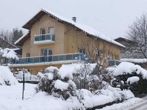a house covered in snow in front at Maison avec jardin Gérardmer L'AUTOUR in Gérardmer