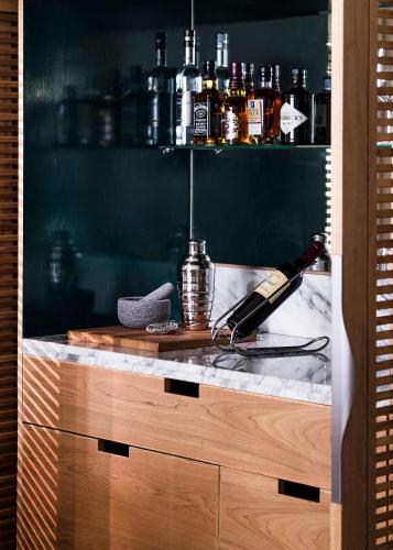 a bar with a bottle of alcohol on a counter at One&Only Le Saint Géran, Mauritius in Belle Mare