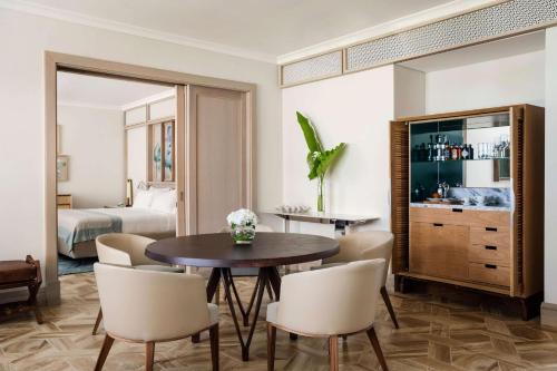 a living room with a table and chairs and a bed at One&Only Le Saint Géran, Mauritius in Belle Mare