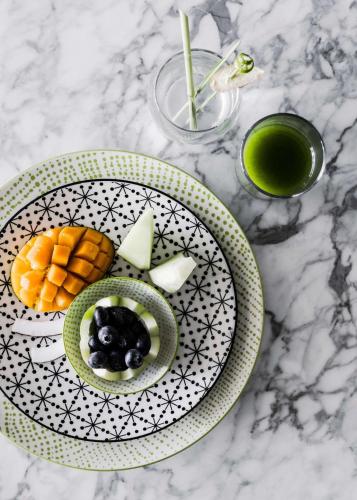 a plate of food with fruit on a table at One&Only Le Saint Géran, Mauritius in Belle Mare