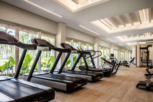 a row of treadmills in a gym with windows at One&Only Le Saint Géran, Mauritius in Belle Mare