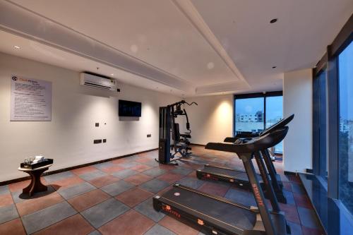 an exercise room with a treadmill and a gym at Click Hotel Shamshabad - Hyderabad Airport in Hyderabad