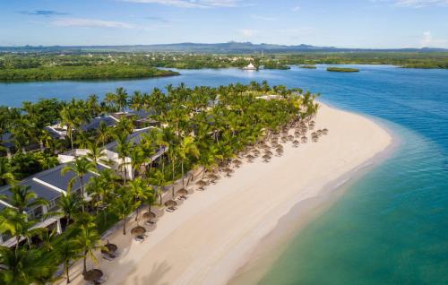 an aerial view of a beach with palm trees at One&Only Le Saint Géran, Mauritius in Belle Mare