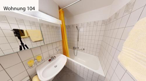 a bathroom with a shower and a toilet and a sink at Schweizerhaus Apartments in Maloja