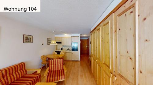 a living room with a couch and a table at Schweizerhaus Apartments in Maloja