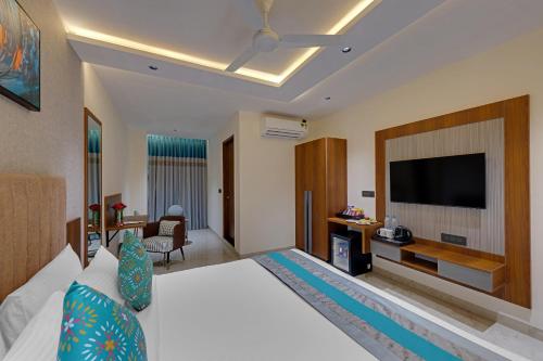 a hotel room with a bed and a flat screen tv at Click Hotel Shamshabad - Hyderabad Airport in Hyderabad