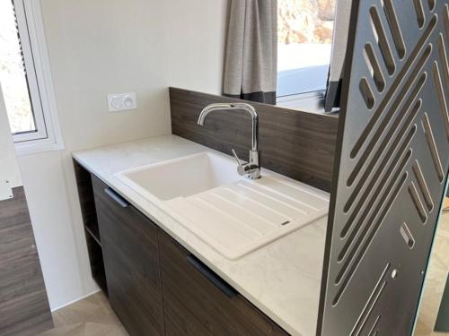 a kitchen with a sink and a counter top at Domaine de l' Ile d' or in La Celle-sous-Gouzon