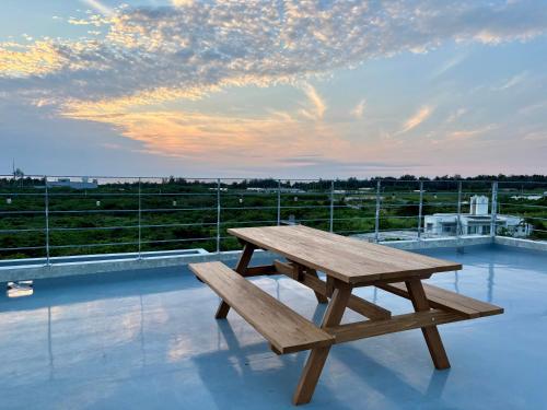 a wooden picnic table sitting on top of a roof at CondoYumangi in Onna