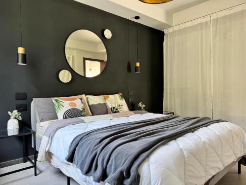 a bedroom with a large bed and a mirror at ApartRiva in historical center near Lake in Riva del Garda