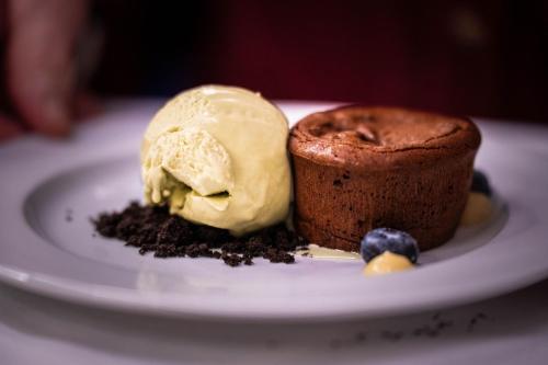 a chocolate cake and ice cream on a plate at Landhotel in Hella