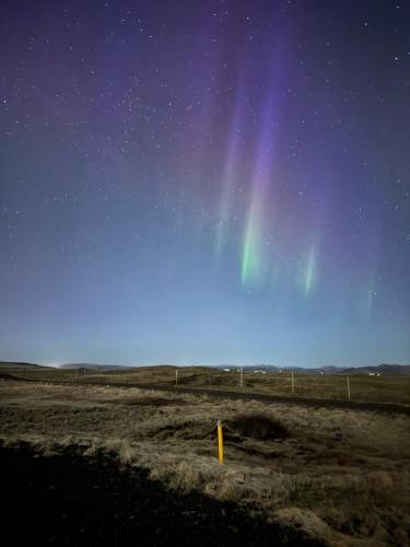 a rainbow in the sky over a field at night at Landhotel in Hella