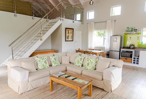 a living room with a couch and a table at The Suites at Waterryk Eco Guest Farm in Stilbaai
